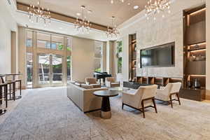 Tiled living room with french doors and a towering ceiling