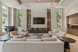 Living room with a wealth of natural light and a high ceiling