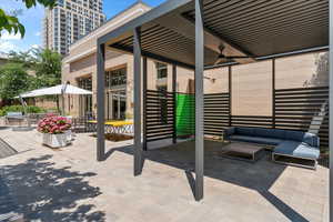 View of patio with an outdoor hangout area and ceiling fan