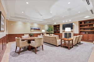 Dining area featuring built in features, light tile patterned floors, and a tray ceiling