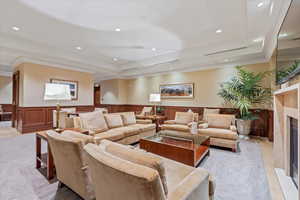 Living room with a fireplace and a raised ceiling