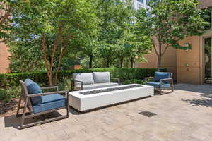 View of patio featuring an outdoor living space with a fire pit