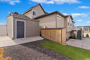 Back of property with walk-out basement, composite deck and shed.