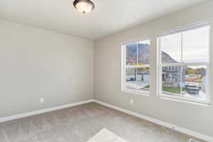 Unfurnished room featuring light colored carpet