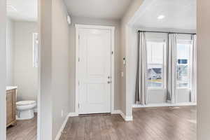 Foyer entrance with light hardwood / wood-style flooring and lots of natural light