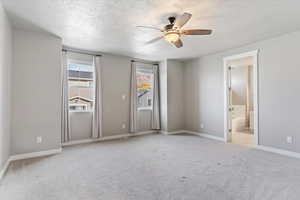 Main bedroom featuring, ensuite bathroom, ceiling fan, and light colored carpet