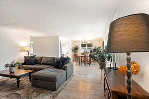 Living room with light hardwood / wood-style flooring and crown molding