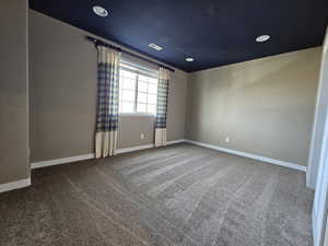 Unfurnished room with carpet