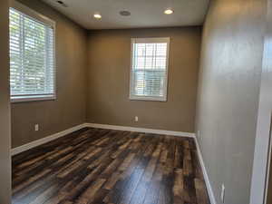 Spare room with dark wood-type flooring