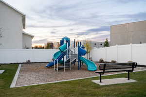 Playground at dusk featuring a yard