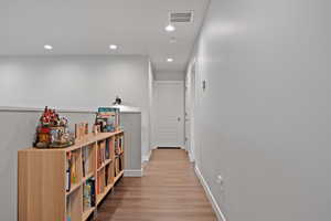 Corridor featuring hardwood / wood-style flooring