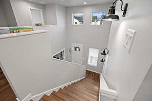 Staircase featuring wood-type flooring