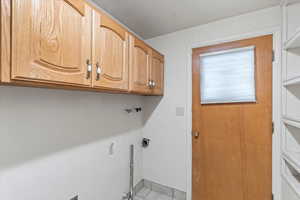 Washroom with light tile patterned floors and cabinets