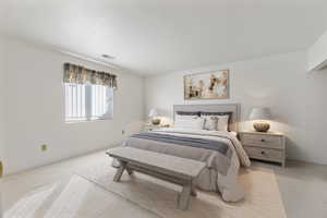 Bedroom featuring light carpet