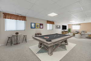 Playroom with a drop ceiling, carpet, and billiards