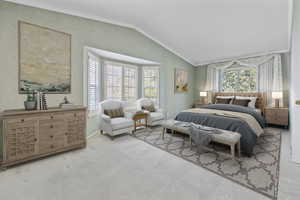 Bedroom featuring light carpet, ornamental molding, and lofted ceiling