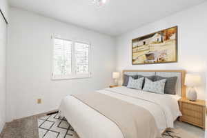 Bedroom featuring light colored carpet