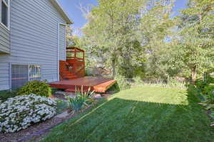 View of yard with a wooden deck