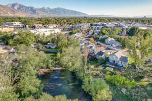 Birds eye view of property featuring a water and mountain view