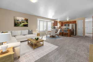 Living room featuring a chandelier and light carpet