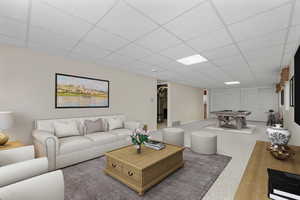 Living room featuring a paneled ceiling