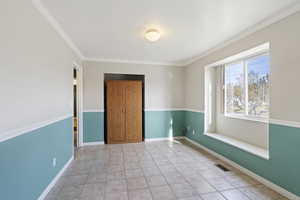 Tiled empty room with ornamental molding