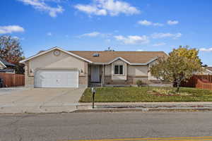 Single story home with a front lawn and a garage