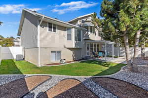 Back of property with a yard and a patio area