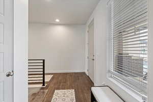 Hall featuring dark wood-type flooring