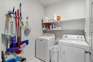 Clothes washing area featuring separate washer and dryer