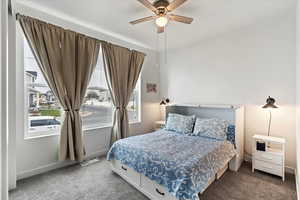 Carpeted bedroom with ceiling fan