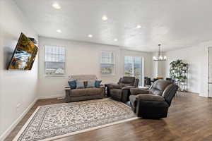 Living room featuring a textured ceiling, and dark hardwood / wood-style floors