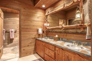 Bathroom featuring wooden walls and vanity