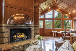 Living room with light hardwood / wood-style flooring, plenty of natural light, and wooden walls