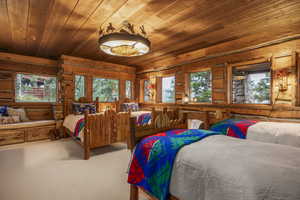 Carpeted bedroom with wood ceiling