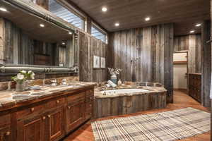 Bathroom featuring wooden walls and hardwood / wood-style flooring