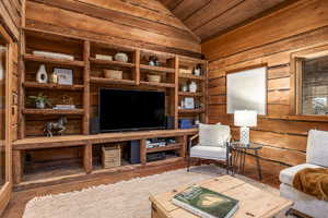 Interior space with hardwood / wood-style floors, wooden ceiling, and lofted ceiling