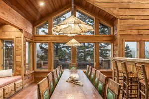 Dining room featuring light hardwood / wood-style flooring, a wealth of natural light, and wood ceiling