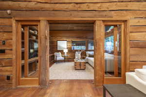 Living room with hardwood / wood-style floors and beamed ceiling