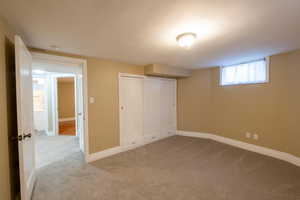 Unfurnished bedroom with a closet and light carpet