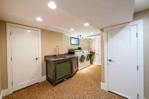 Washroom featuring sink and washer and dryer