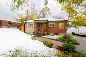 View of front of home with an outbuilding and a garage