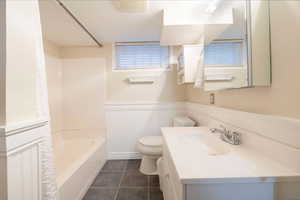 Full bathroom with vanity, shower / bathing tub combination, toilet, and tile patterned flooring