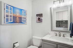 Bathroom featuring vanity and toilet