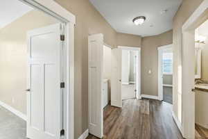 Corridor featuring sink and hardwood / wood-style flooring