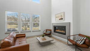 Sitting room featuring a high ceiling and light hardwood / wood-style flooring