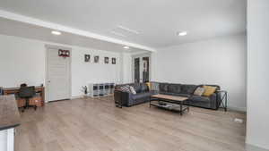 Living room with light wood-type flooring