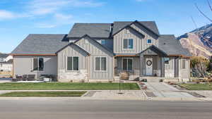 View of front facade with an outdoor living space and a front lawn