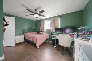 Bedroom featuring ceiling fan and dark hardwood / wood-style flooring