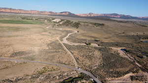 Aerial overview of property's location featuring a mountainous background and rural landscape